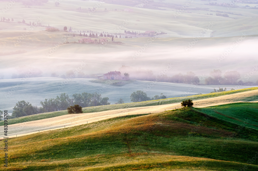 May morning. View of the fields lit by the rays of the sun. Tuscany.