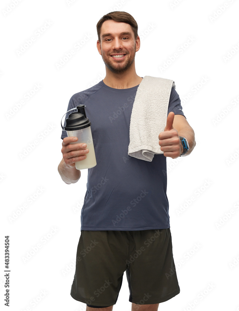 fitness, sport and healthy lifestyle concept - smiling man in sports clothes with protein shake bottle and towel showing thumbs up over white background fitness, sport and healthy lifestyle concept - smiling man in sports clothes with protein shake bottle and towel showing thumbs up over white background