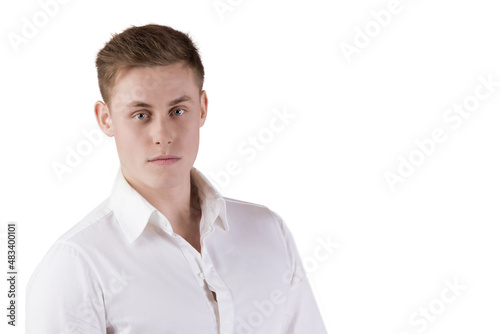 Portrait of a young man in a white shirt on an isolated background. © Светлана Лазаренко