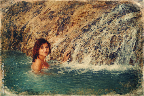beautiful woman near the waterfall.