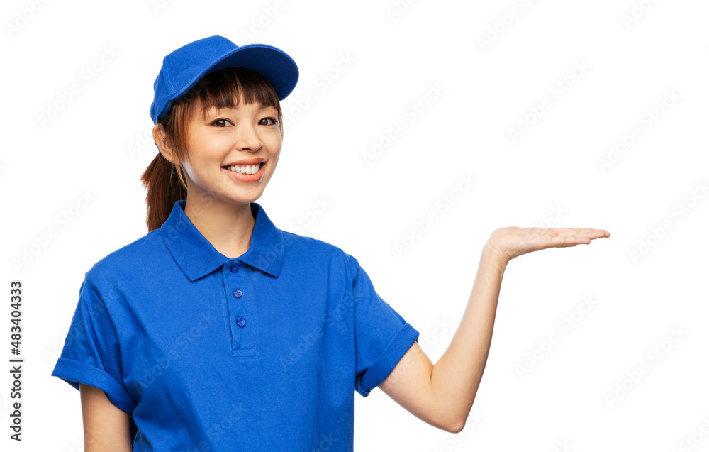 profession, job and people concept - happy smiling delivery woman in blue uniform holding something imaginary on her hand over white background profession, job and people concept - happy smiling delivery woman in blue uniform holding something imaginary on her hand over white background
