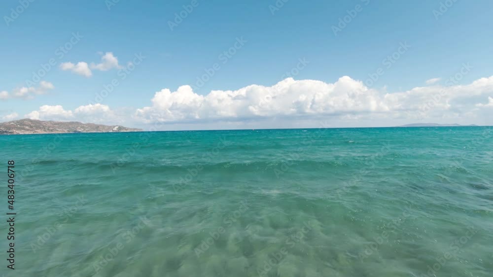 Fast flight from the coast above the surface above the surface of the water. Beautiful azure Mediterranean coast, Crete, Greece Fast flight from the coast above the surface above the surface of the water. Beautiful azure Mediterranean coast, Crete, Greece