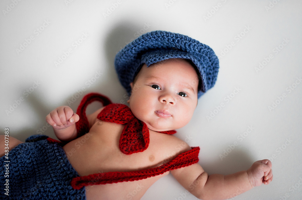 Soft picture of a beautiful baby boy 1-3 months laying on white bedding wearing crochet costume, newborn photography Soft picture of a beautiful baby boy 1-3 months laying on white bedding wearing crochet costume, newborn photography