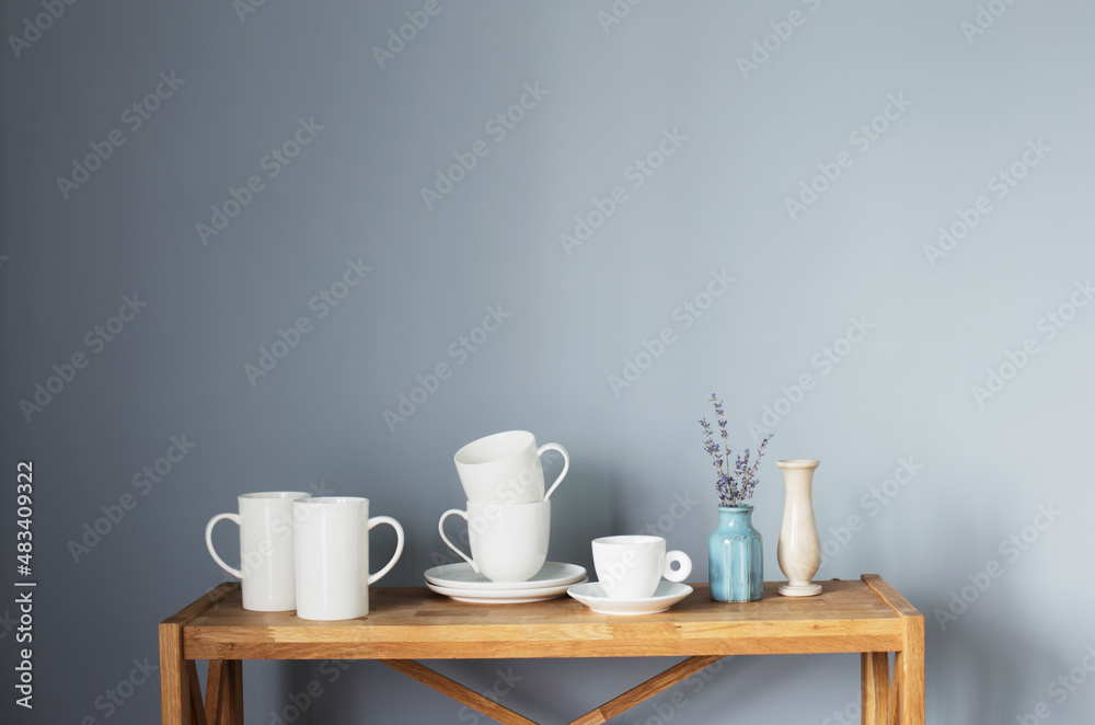 white cups and vases on wooden shelf on gray background white cups and vases on wooden shelf on gray background