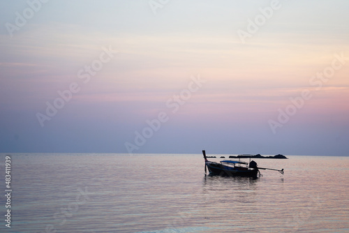 local fishing boat floating in the sea and colorful sunshine in early morning
