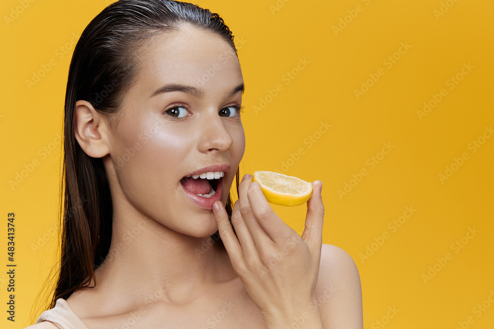 young woman with lemon near face clean skin care health yellow background young woman with lemon near face clean skin care health yellow background