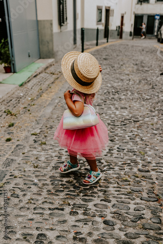 a little girl in a pink princess dress in funchal madeira portugal 