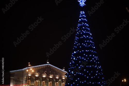 City Gomel Drama Theatre with Christmas illumination and festive Christmas tree on the square photo