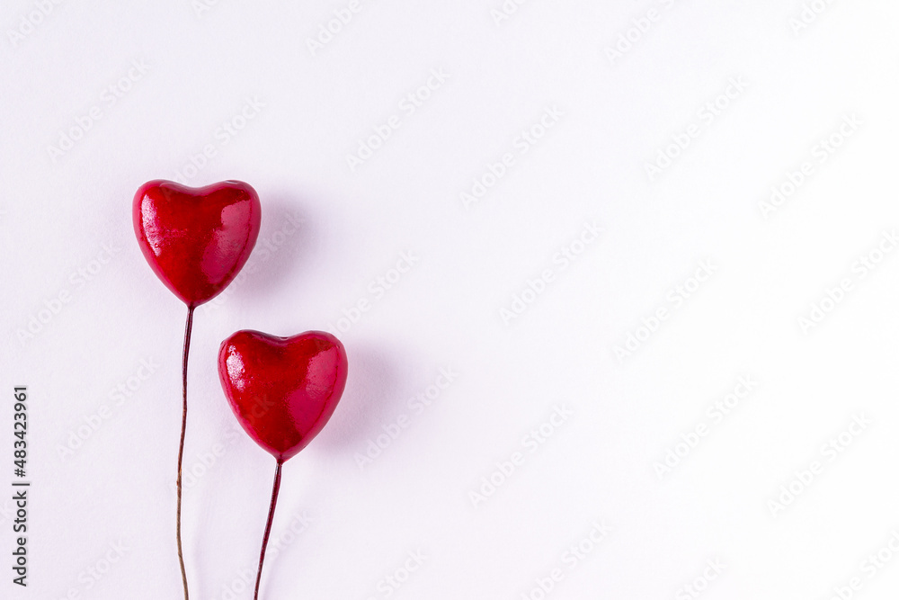 two wooden red hearts on white background, copy space