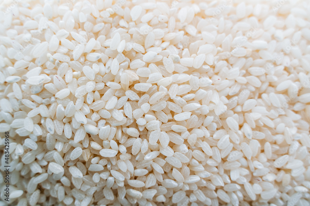 rice groats top view. White rice is shot close-up. The grains are in heaps. rice groats top view. White rice is shot close-up. The grains are in heaps.