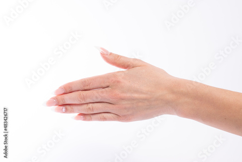 Woman hand showing a greeting gesture on white background