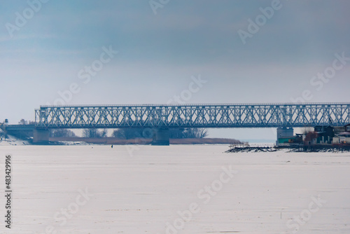 Iron bridge over a frozen river photo