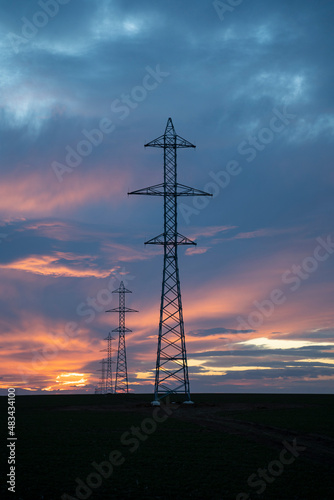 New installed barriers for electricity transmission in the meadows during the sunset.