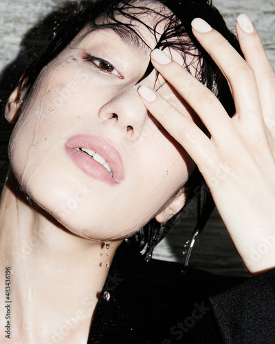 Girl in the shower. Black suit. Short wet hair. Beautiful eyes and lips. Brunette. Young, crazy and cool. Clean white skin. Nice shape. Good quality. Flash light. Modern and stylish. Asian type model