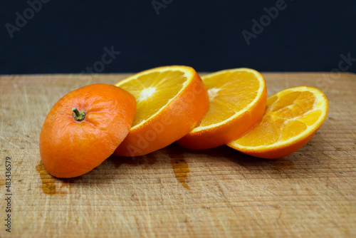Cutted oranges on wooden cutting board