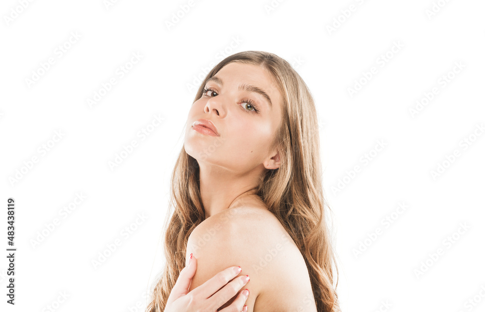 Beautiful girl touching her shoulder and posing in studio Beautiful girl touching her shoulder and posing in studio