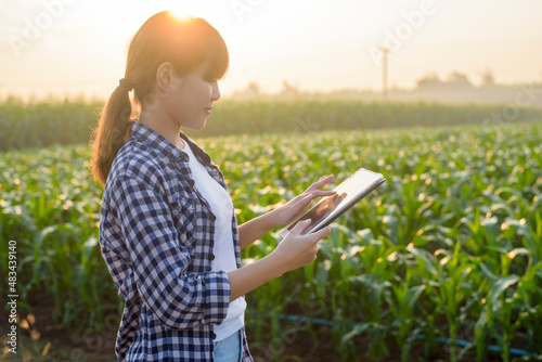 Young female smart farmer with tablet on field High technology innovations and smart farming