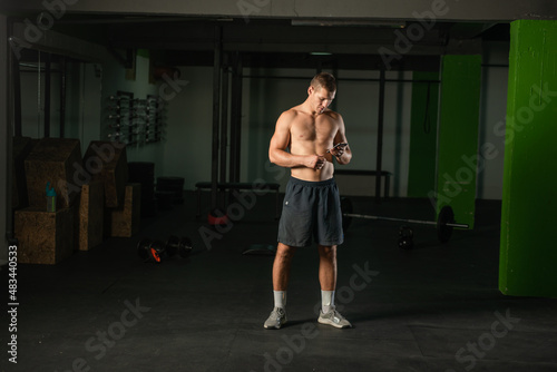 Portrait of a shirtless athlete preparing for a workout.