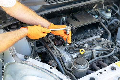 Fotografie, Obraz Car spark plug replacement. Repairing of vehicle.