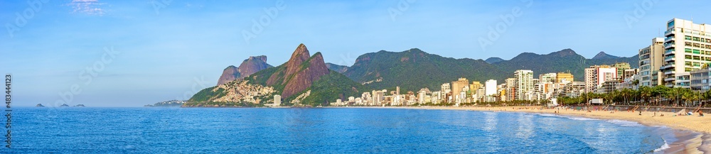 Panoramic image of Ipanema beach in Rio de Janeiro with the sea, mountains and buildings on a summer morning.