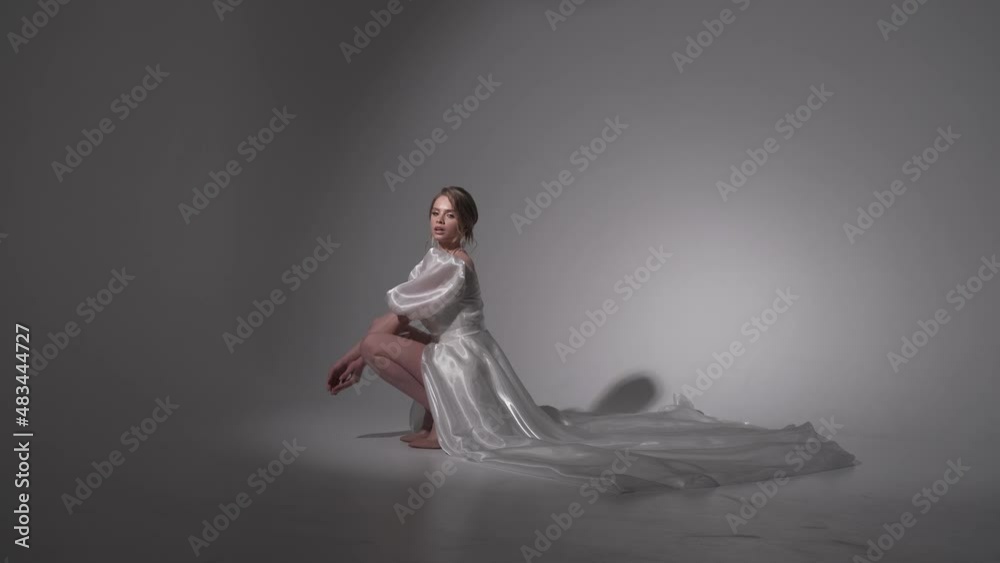european model sits in an empty room european model sits in an empty room