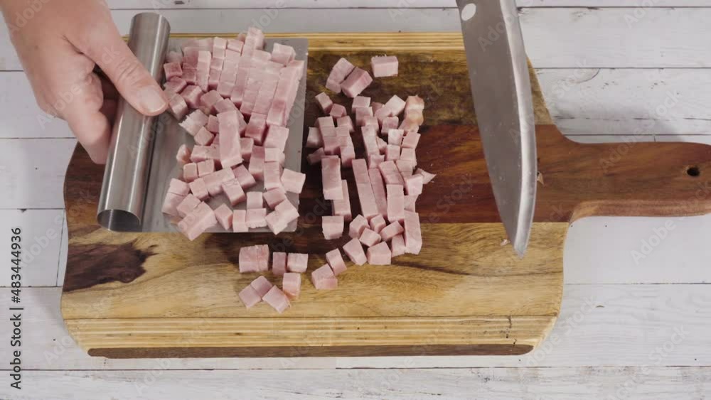 Cutting organic honey ham on a wood cutting board. Cutting organic honey ham on a wood cutting board.