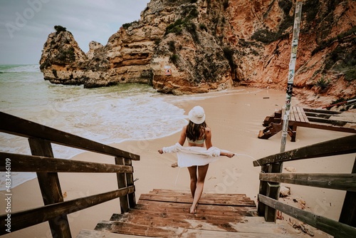 woman on the beach in lagos algarve portugal 