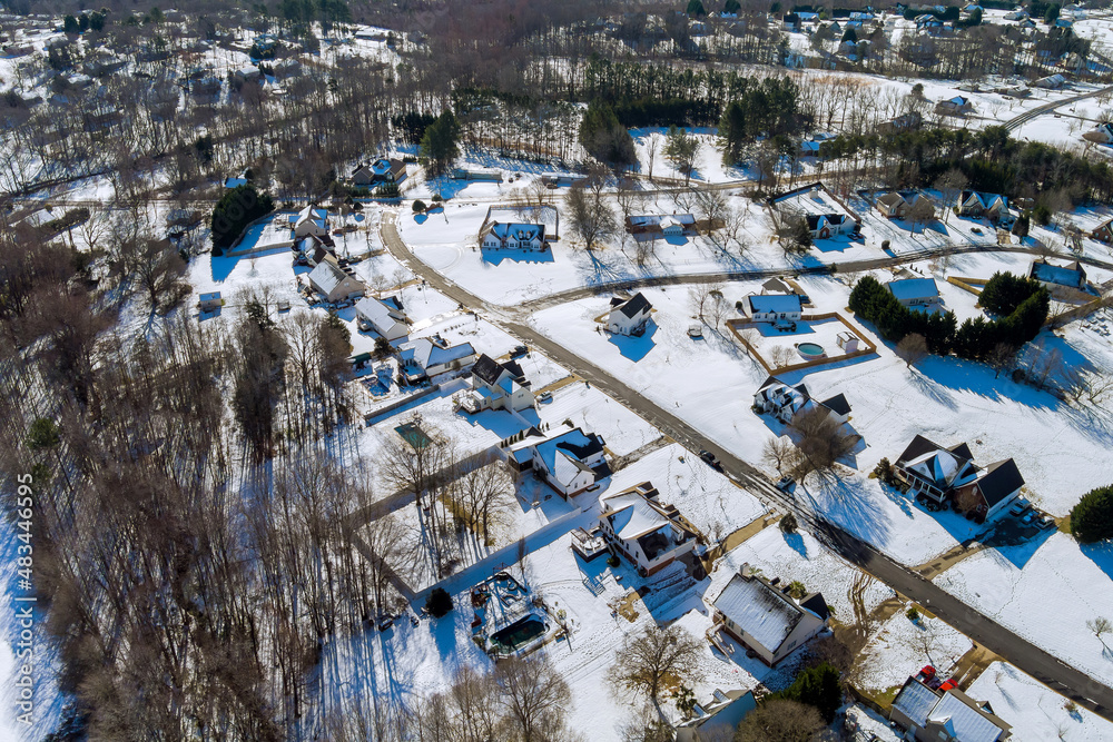 Aerial view of landscape top of the winter town residential houses with snow covered houses and roads.