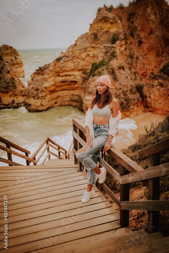 woman on the beach in lagos algarve portugal 