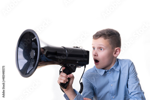 Boy shouting into a large black megaphone from the front with a white background