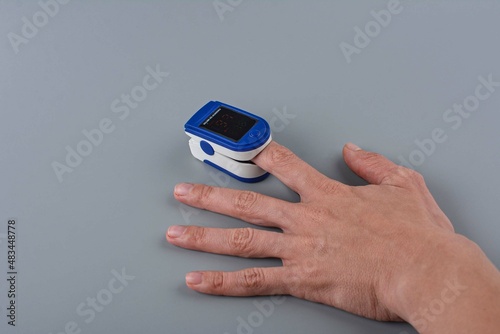 Pulse oximeter on a female hand.
