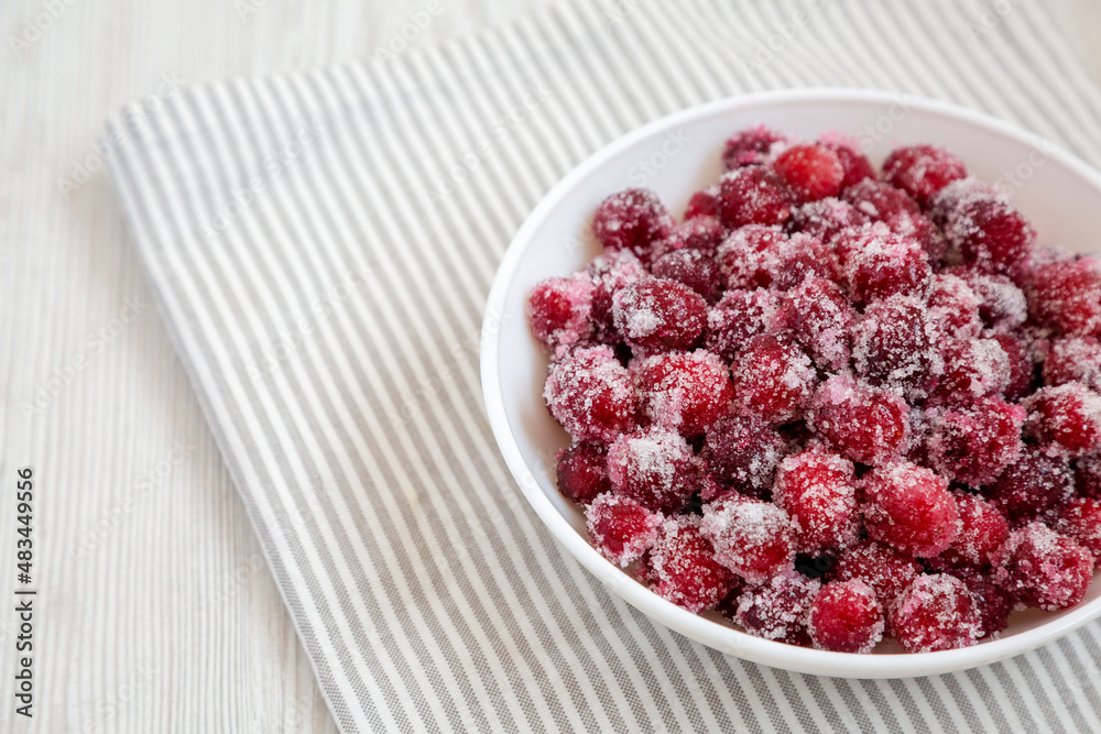 Red Sugared Cranberries in a Bowl, side view. Copy space. Red Sugared Cranberries in a Bowl, side view. Copy space.