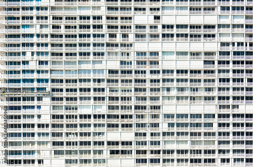 Facade of a multi-storey residential building with windows and balconies. Facade of a multi-storey residential building with windows and balconies.