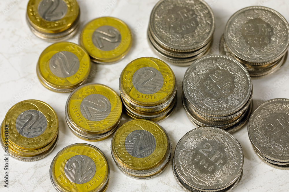 Stacks of Polish zloty and Swiss franc coins Stacks of Polish zloty and Swiss franc coins