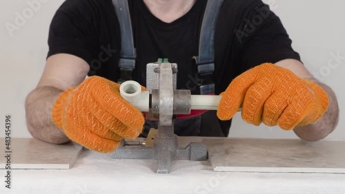 Work on the installation of heating or plumbing.  Male  plumber welding plastic pipes plumbing installation