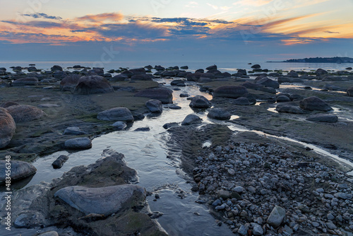 Rocky coast of Baltic sea at sunset. Low tide © yegorov_nick