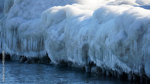 Ice and snow covered rocks along the shoreline of Lake Michigan at Gillson Beach in Wilmette, Illinois.   photo