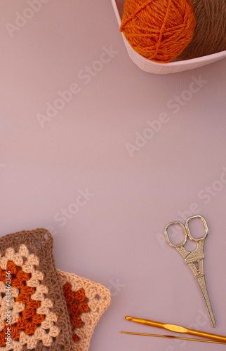background with balls of yarn and tools for knitting