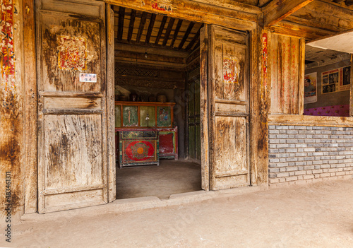 Wooden door in the facade of a traditional house in Huzhu  Qinghai province  China