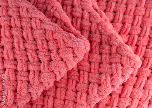 Blurred image of pink knitted fabric background.