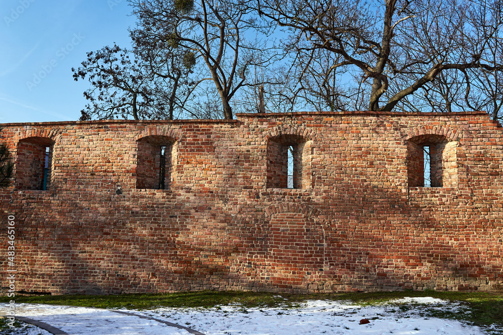 Fragment of a medieval brick defensive wall  during winter