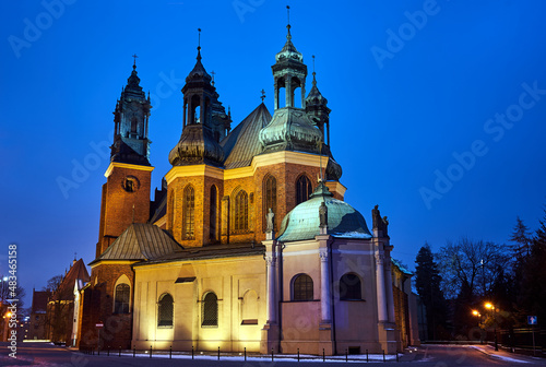 the historic towers of the Gothic cathedral at night in Poznan
