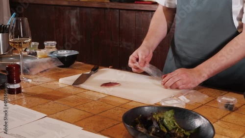 The chef on the stream prepares a dish of fried fish with broccoli and sauce