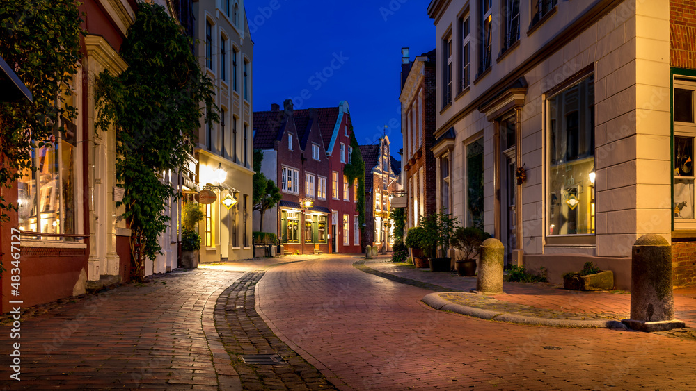 illuminated alley in the old town of Leer in the blue hour
