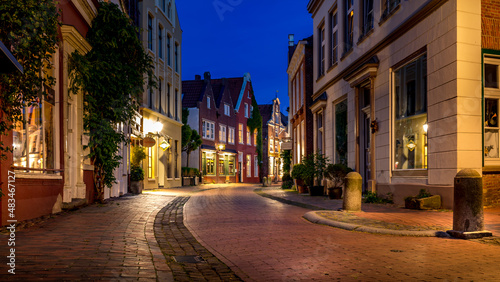 illuminated alley in the old town of Leer in the blue hour