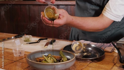The chef on the stream prepares a dish of fried fish with broccoli and sauce