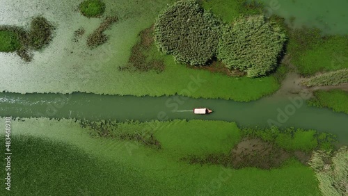 aerial view of tour boat on Lake Skadar with water green lilies and water chestnut. Lake Scutari, Shkoder or Shkodra. popular tourist destination. National Park. Montenegro. river Rjieka Crnojevica photo