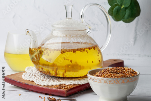 
Tea in a transparent teapot. Place for text. Buckwheat tea and granules.