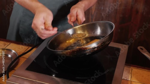 The chef on the stream prepares a dish of fried fish with broccoli and sauce