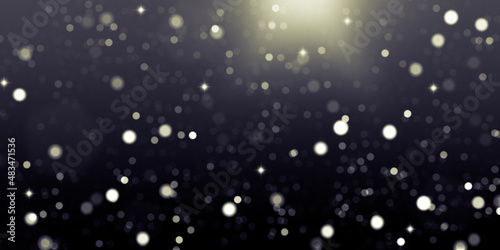 Defocused bright lights on black abstract background